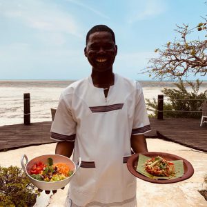 Jua man with plates of food